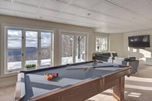 a living room with a pool table in a room at Ski-in/Car-out, HOT TUB with Amazing sunset view in Saint-Faustin