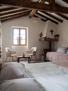 a bedroom with two beds and a cross on the wall at AUBERGE BORDA in Saint-Michel