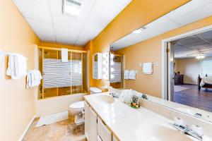 a bathroom with a sink and a toilet and a mirror at Winston Way in Pigeon Forge +18 photos