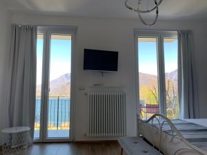 a bedroom with a bed and a tv on a wall at Bregagno B&B in Musso