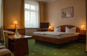 Hotel Meereswelle - Anno 1875 tesisinde bir odada yatak veya yataklar