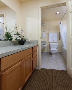 a bathroom with a toilet and a sink at WorldMark Surfside Inn in Ocean Park