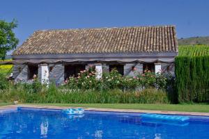 a house with a swimming pool in front of it at Holiday Home Finca Retama in Ronda