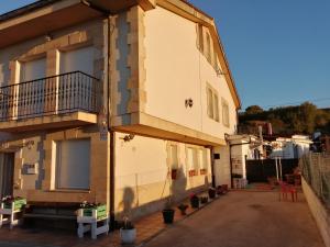 a building with a balcony on the side of it at Somonte Costa in Santander