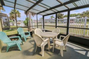 a patio with chairs and a table and chairs at St Augustine Beach & Tennis Resort 615 in Saint Augustine
