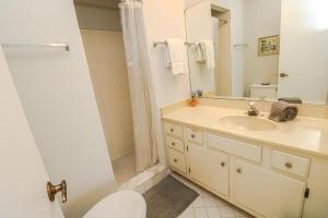 a bathroom with a sink and a toilet and a mirror at St Augustine Beach & Tennis Resort 615 in Saint Augustine