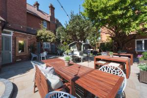 an outdoor patio with a wooden table and chairs at Florence Suite Boutique Hotel and Restaurant in Portsmouth