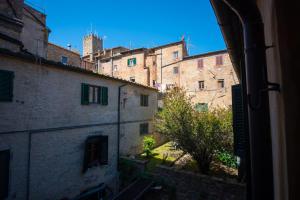 a view from a window of an alley with buildings at Il Giardino Segreto B&B in Volterra +22 photos