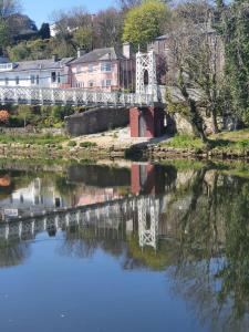 a bridge over a river with houses in the background at River View Apartment Suite in Cork