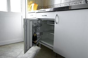 an open refrigerator with a bottle of wine in it at Aпартаменты Влаович in Igalo