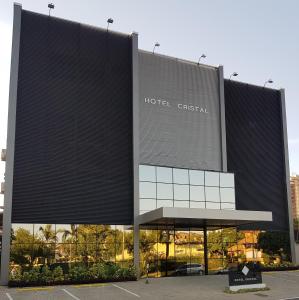 a building with a hilton christiana sign on it at Hotel Cristal Rio Claro in Rio Claro