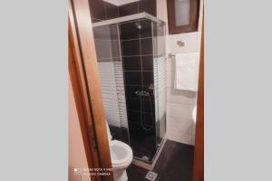 a bathroom with a toilet and a glass shower at Georgia's Village House in Kaláthenai +22 photos