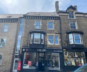 a store in front of a brick building at Solomons Peak Apartment in Buxton