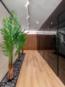 a conference room with two palm trees in the middle at The Newel Acropolis in Athens