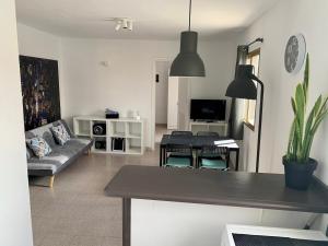 a living room with a couch and a table at Fuerteventura apartament Monny Moulin View Antigua Wi-Fi in Valles de Ortega