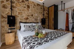 a bedroom with a bed with a tray of fruit on it at Rodillo Apartments in Plaka