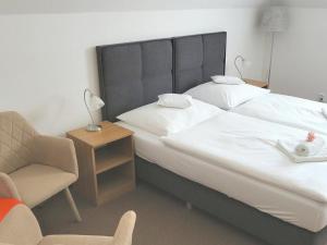 Posteľ alebo postele v izbe v ubytovaní Hotel U Brány