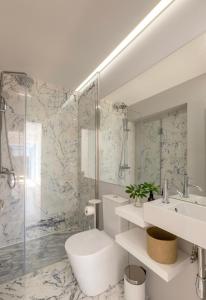ein Bad mit einer Dusche, einem WC und einem Waschbecken in der Unterkunft Lemon Tree Family Apartment in Porto