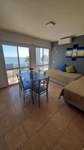 a living room with a table and chairs and a bed at Amanecer Petit in Miramar