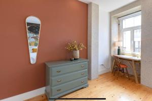 a bedroom with a dresser and a mirror and a desk at The Kiss - 1 bedroom apt with terrace in Porto