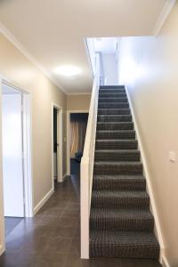 a stairway in a house with a hallway at Marina Hotel in Port Lincoln