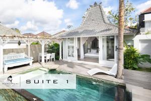 a villa with a swimming pool and a house at Mahi Mahi Villa & Suites in Uluwatu