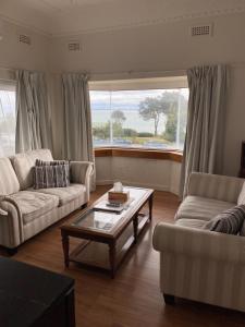 a living room filled with furniture and a window at Stella's Dromana Hotel in Dromana