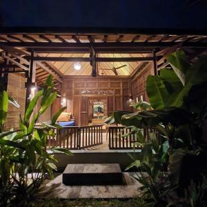 a garden area with a staircase leading to a balcony at Yabbiekayu Eco-Bungalows in Yogyakarta