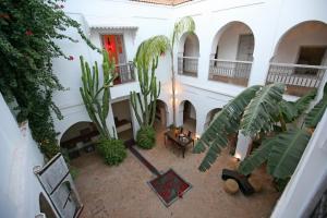 an overhead view of a building with a courtyard with plants at Riad O2 in Marrakech