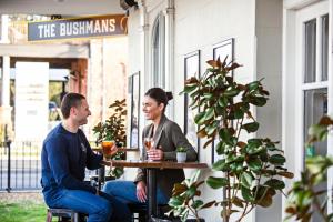 two people sitting at a table outside a restaurant at The Paragon Hotel in Mudgee