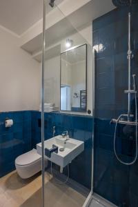 a bathroom with a sink and a toilet and a shower at Na Skałce Apartment in Kraków