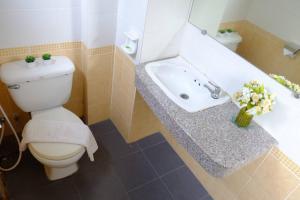 a bathroom with a toilet and a sink at Aileen Hotel in Khon Kaen