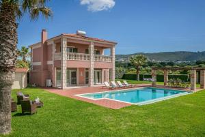 a villa with a swimming pool and a house at Sunset in Minia