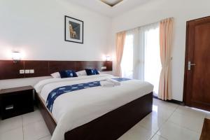 Postel nebo postele na pokoji v ubytování Balkondes Kenalan