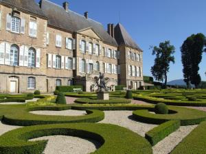 a garden in front of a large building at Hôtel de Bourgogne in La Clayette