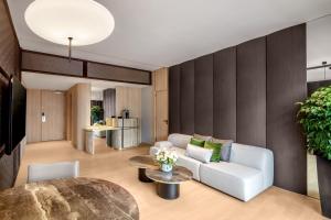 a living room with a couch and a table at PARKROYAL COLLECTION Marina Bay, Singapore in Singapore