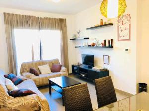 een woonkamer met een bank en een tafel bij casa jaramar in Sanlúcar de Barrameda