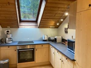 a kitchen with wooden cabinets and a blue counter top at Apartment Stadler in Obertraun
