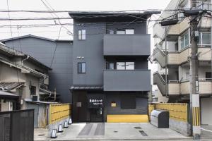 a building with a yellow and black facade at Tofukuji Riverside in Kyoto