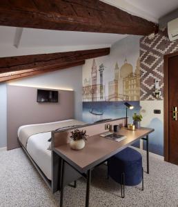 a bedroom with a bed with a desk in it at UNAHOTELS Ala Venezia-Adults 16 in Venice