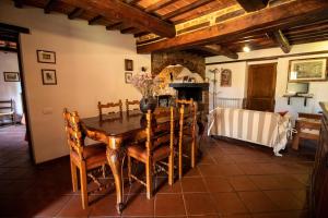 a dining room with a wooden table and chairs at Podere La Vecchia Fornace in Cortona
