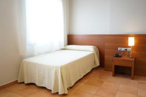 A bed or beds in a room at Hotel Santuari Balaguer