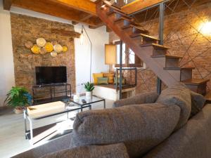 a living room with a couch and a staircase at Casa Canelles (Cod. IUN Q2470) in Iglesias