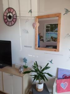 a room with a mirror and a table with a plant at Fewo Happy Heede in Heede