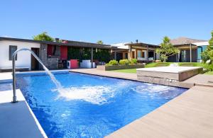 a pool with a water fountain in a house at Luxury and Harmony House in Playa Blanca