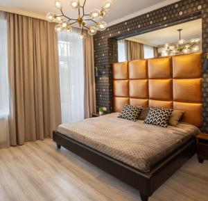 a bedroom with a large bed and a large window at City Garden Apartments in Odesa