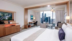 a hotel room with two beds and a television at Marina Bay Sands in Singapore