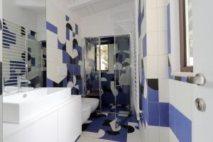a bathroom with a toilet and a sink at Il mulino di Trastevere - My Extra Home in Rome +83 photos