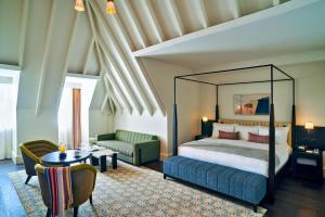 a bedroom with a bed and a living room at The Grand Hotel Birmingham in Birmingham