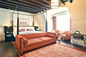 a bedroom with a bed and a couch at The Grand Hotel Birmingham in Birmingham